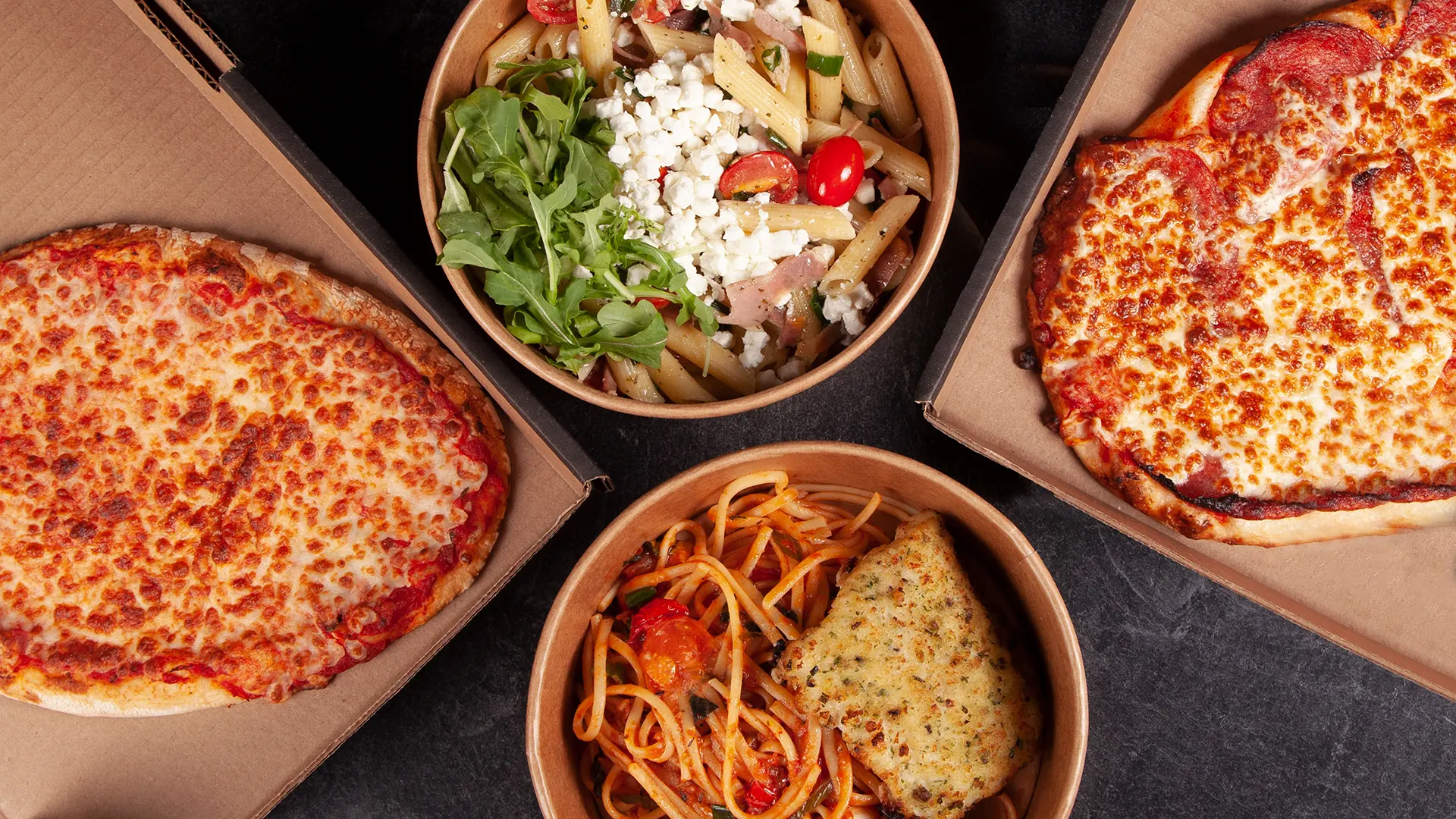 PACINI family meal deal featuring pizzas, pasta, salad, and garlic bread prepared for takeout and delivery.